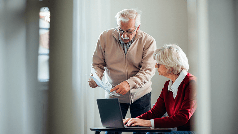 Two adults reviewing paperwork together at a table